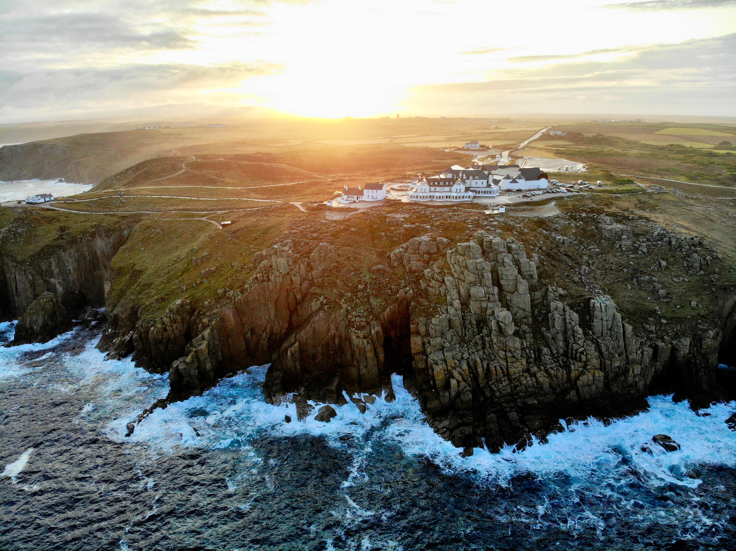Cliffs and visitor buildings at Land’s End on the Atlantic coast of Cornwall at sunset