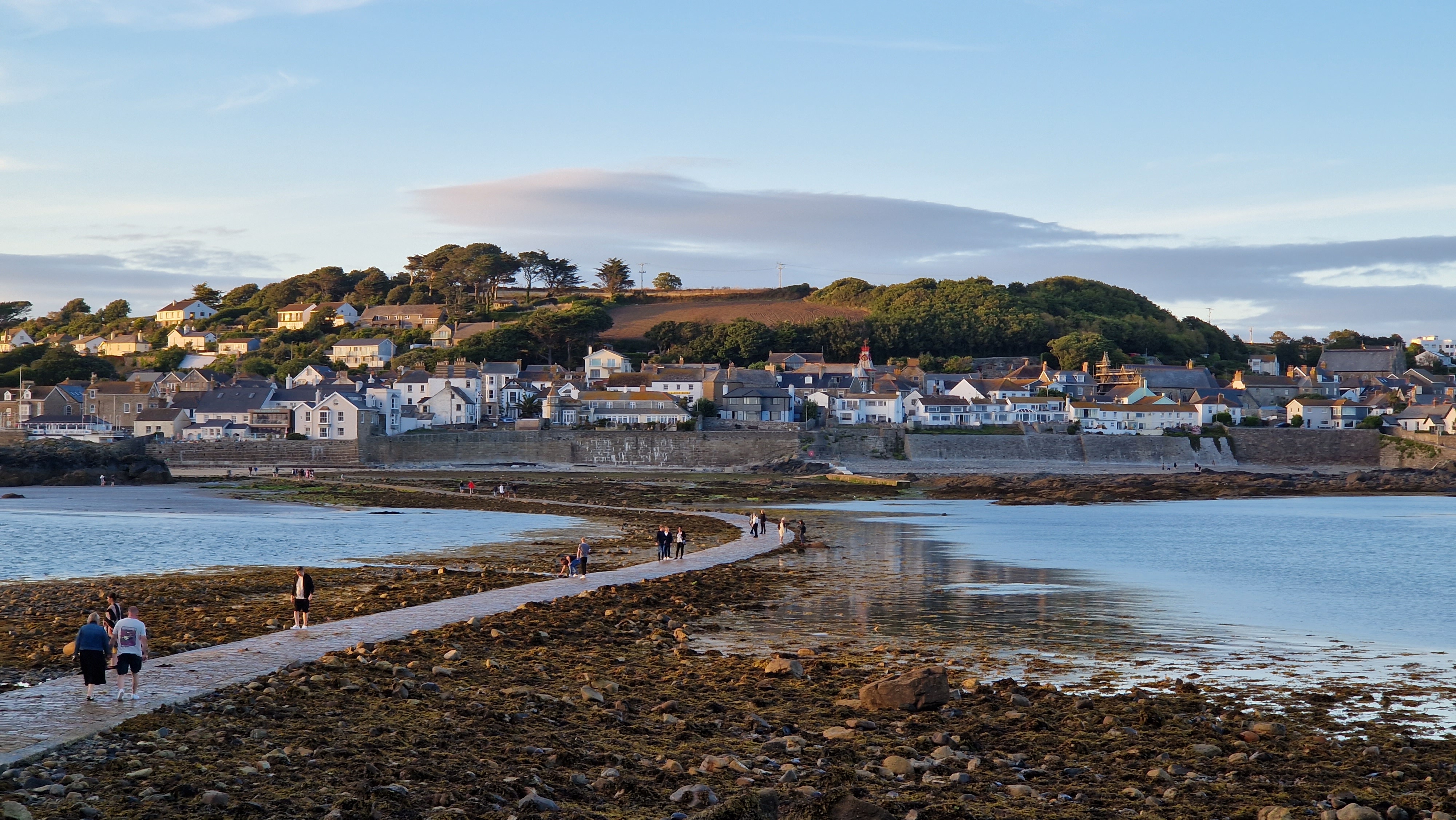 People walking across the stone causeway from Marazion to St Michael’s Mount at low tide