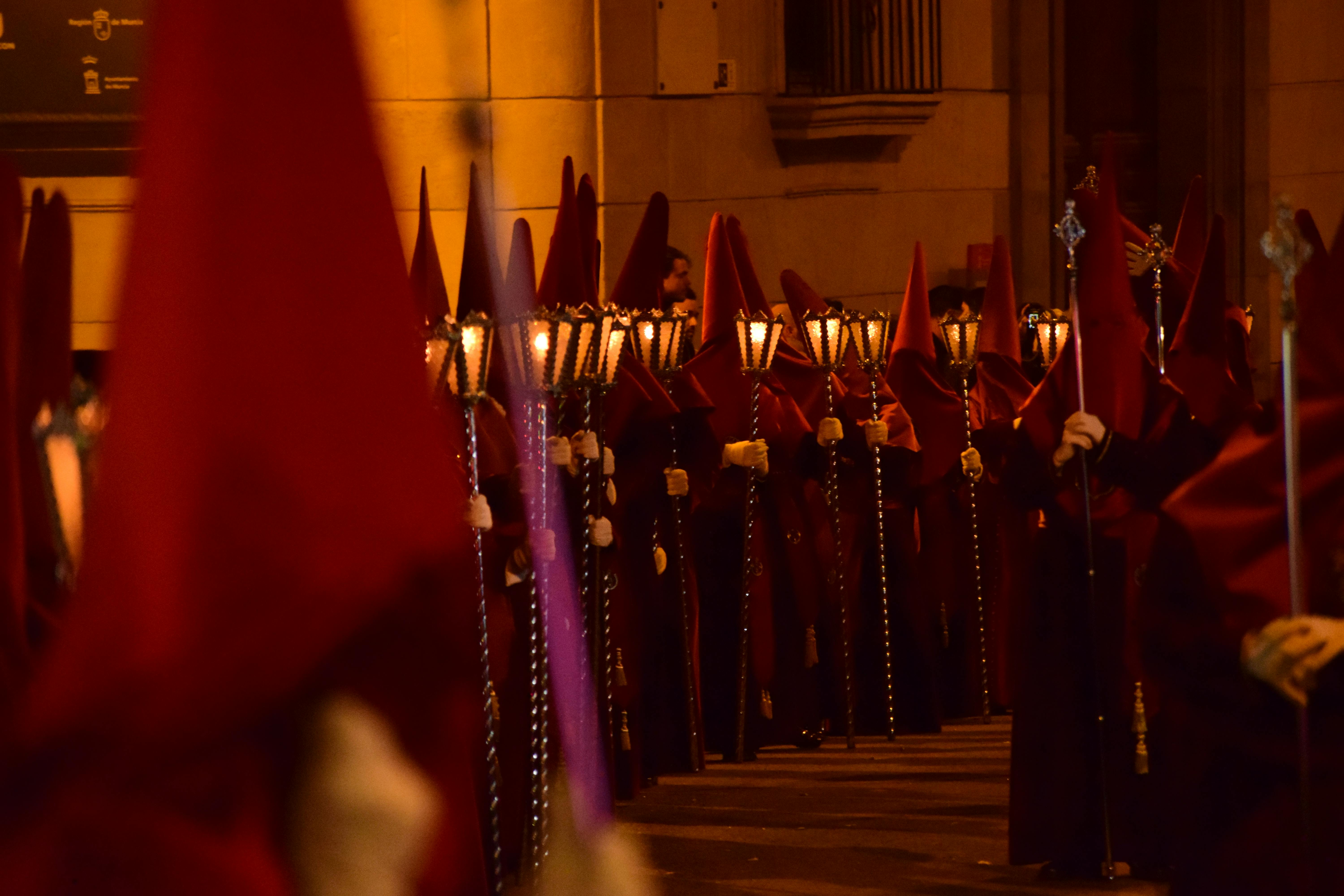 Night-time Holy Week procession in Murcia, with nazarenos carrying lanterns through the historic city streets.
