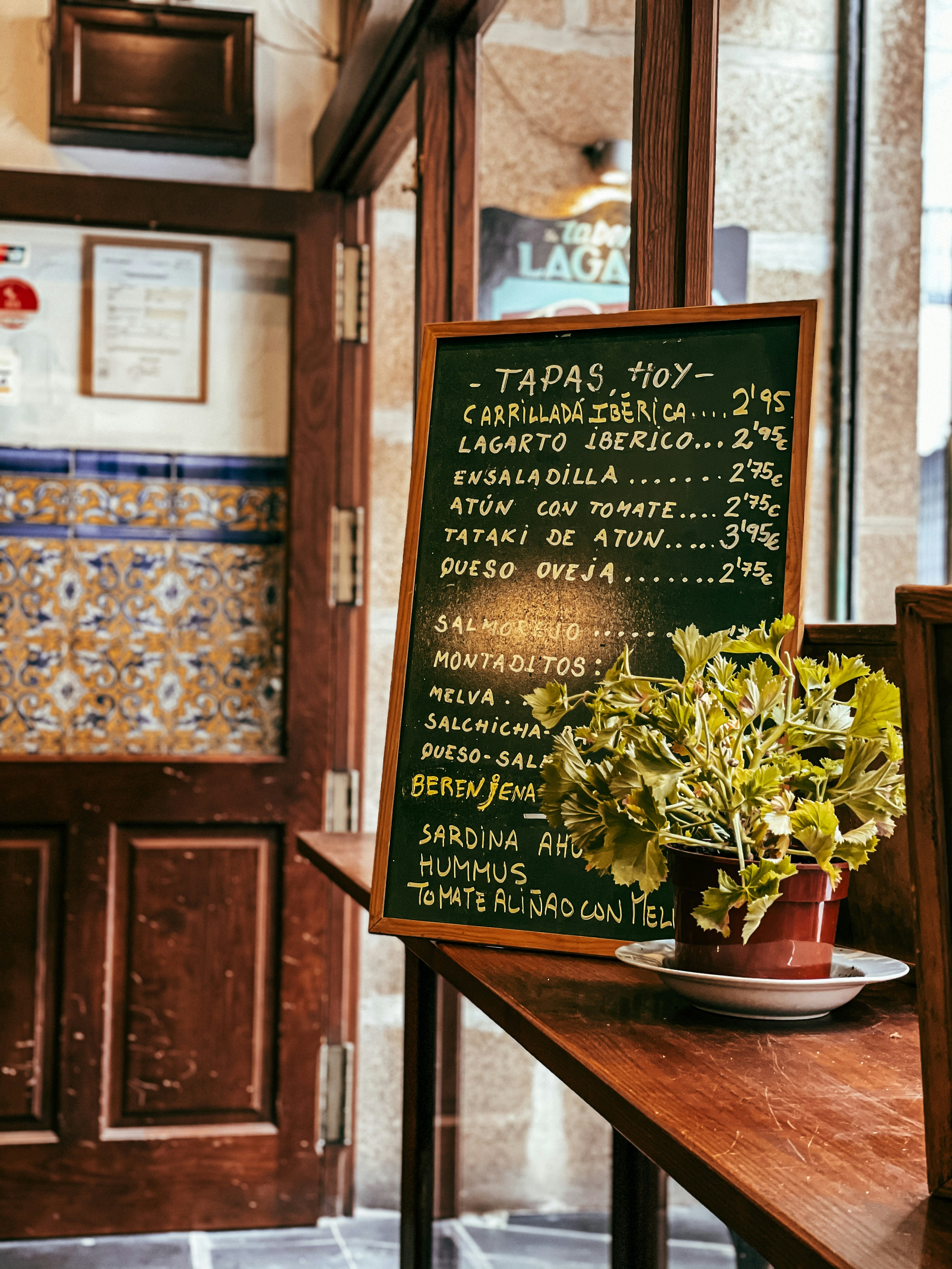 Chalkboard tapas menu inside a bar in Murcia, with local dishes and prices listed.