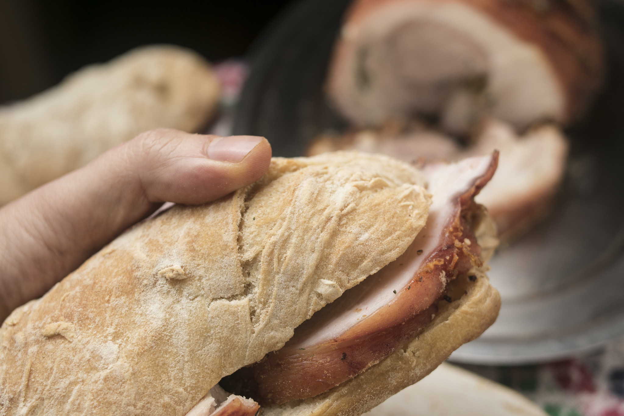 Porchetta sandwich in a ciabatta roll with sliced Italian roast pork and crisp skin