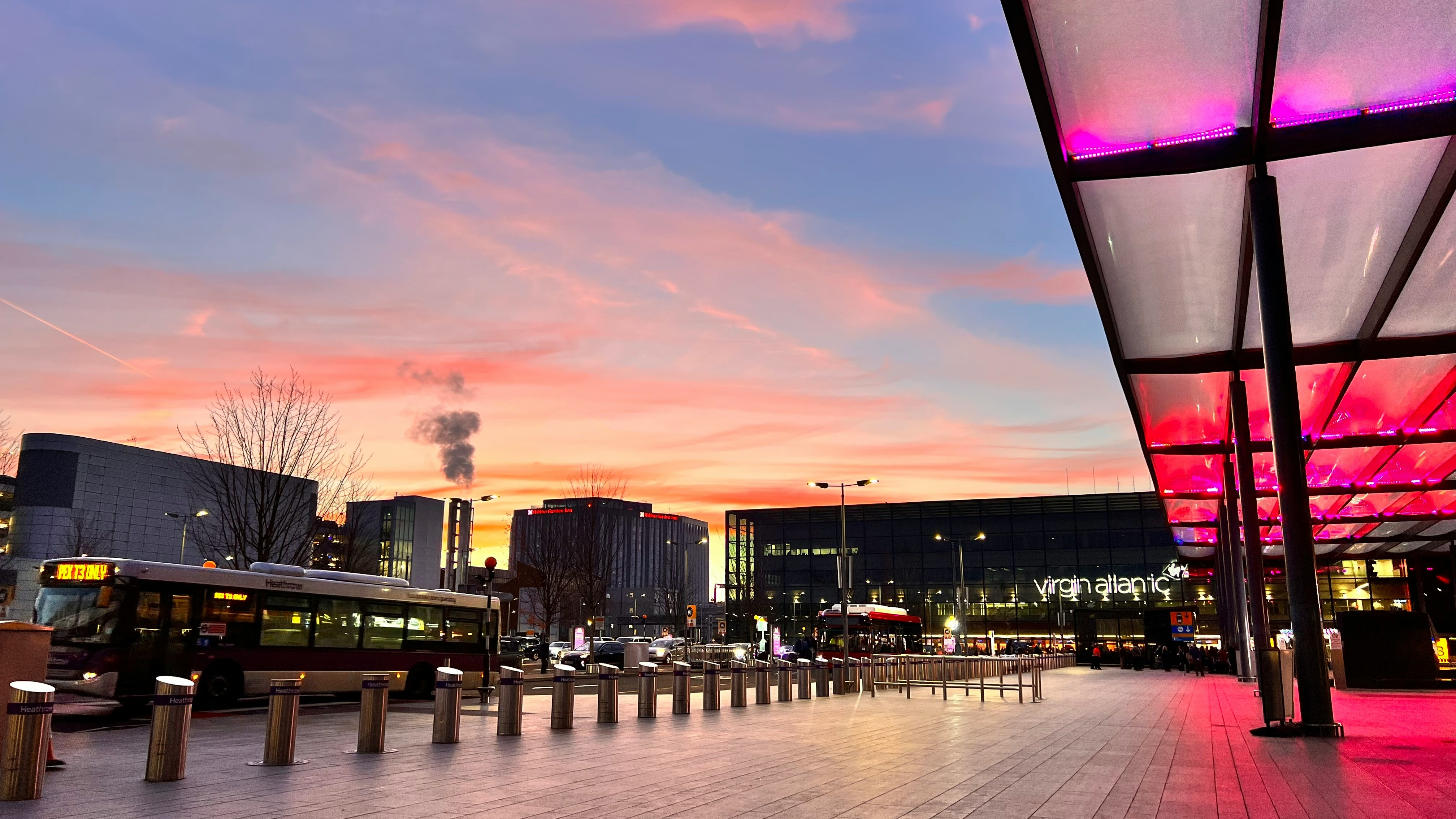 A Heathrow Airport terminal at sunset, one of the most convenient London airports for visitors travelling onwards to Wimbledon.